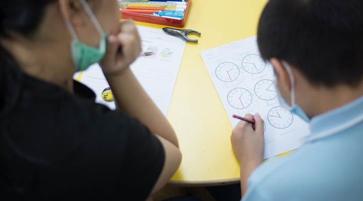 Tutor teaching child
